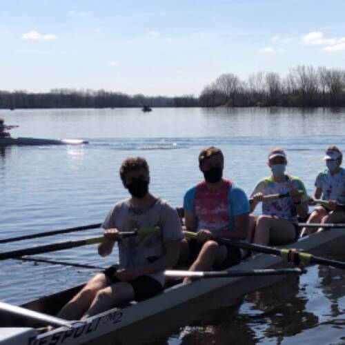 Rowing athlete compete in boats of 4 on Grand River during inter-squad scrimmage.